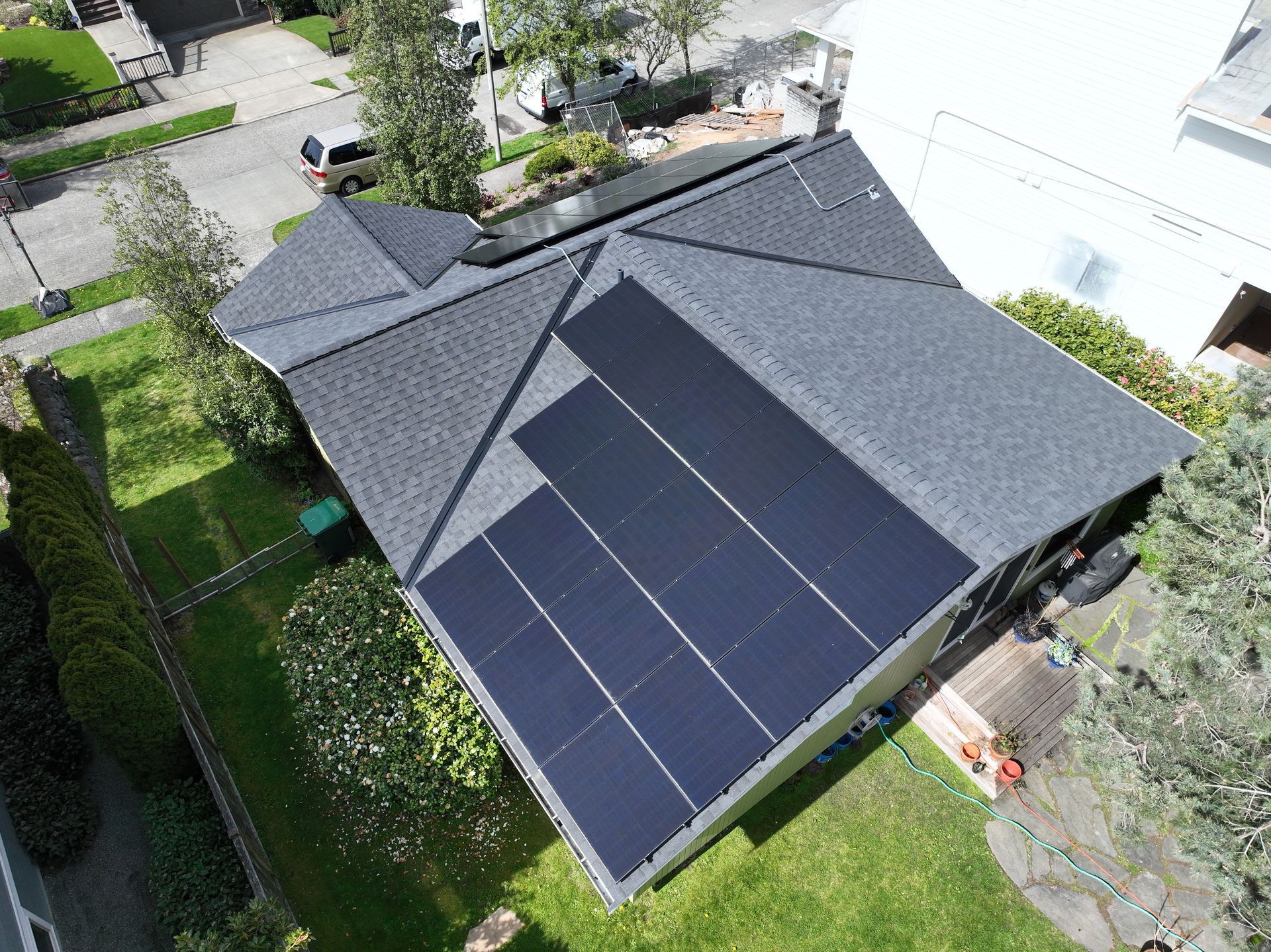 An aerial view of a house with solar panels on the roof.