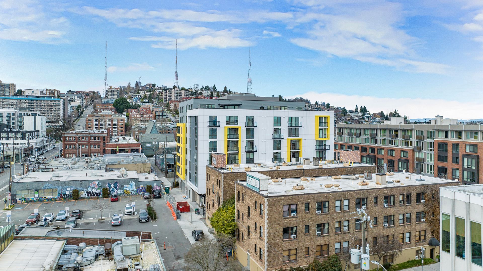 An aerial view of a city with a large building in the middle of it.