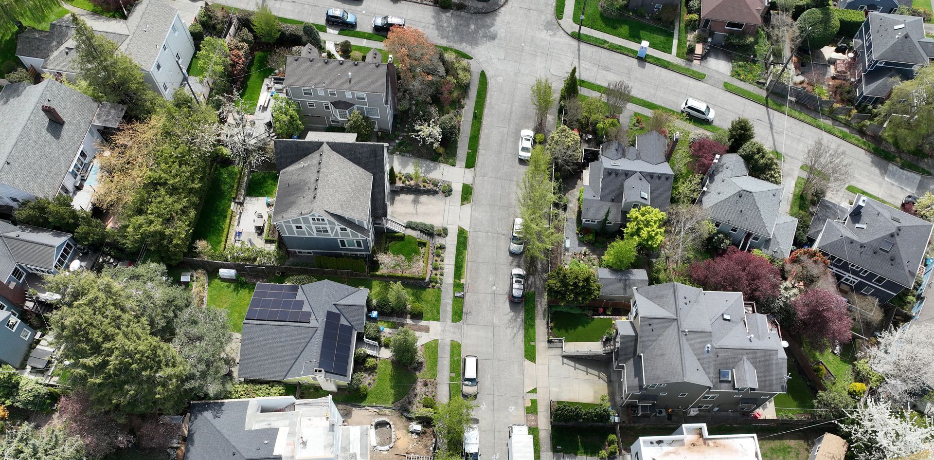 An aerial view of a residential neighborhood with lots of houses and trees.