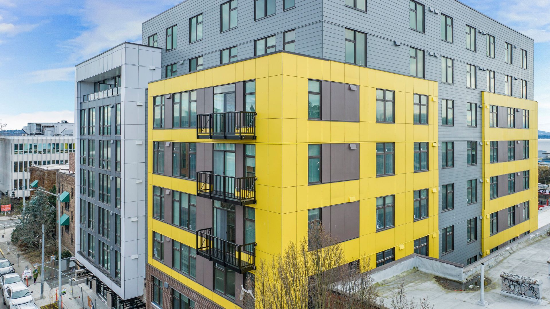 An aerial view of a large yellow building with a fire escape.