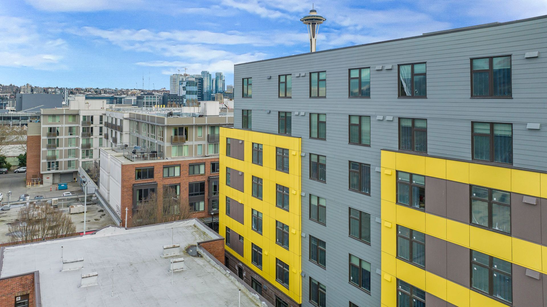 An aerial view of a large building with a lot of windows in a city.