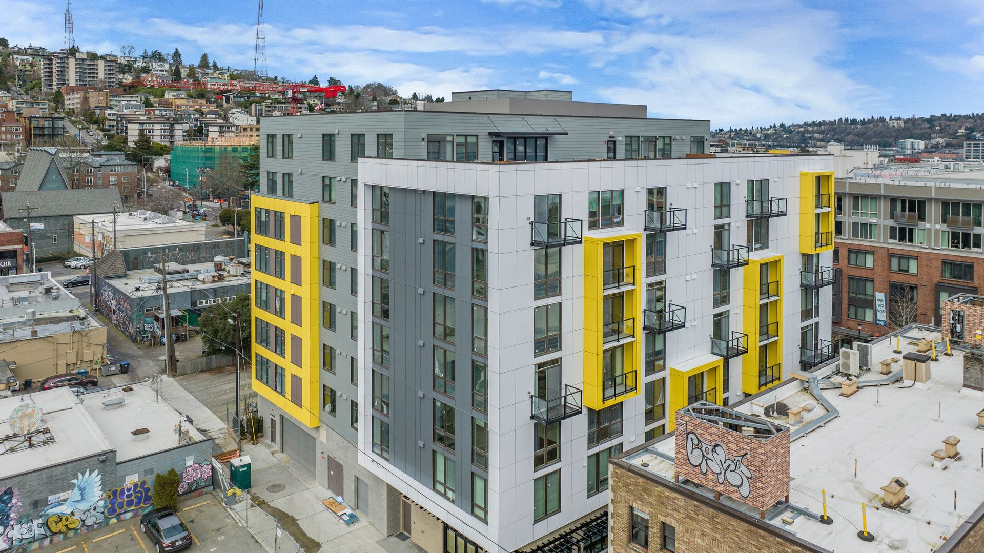An aerial view of a building under construction in a city.