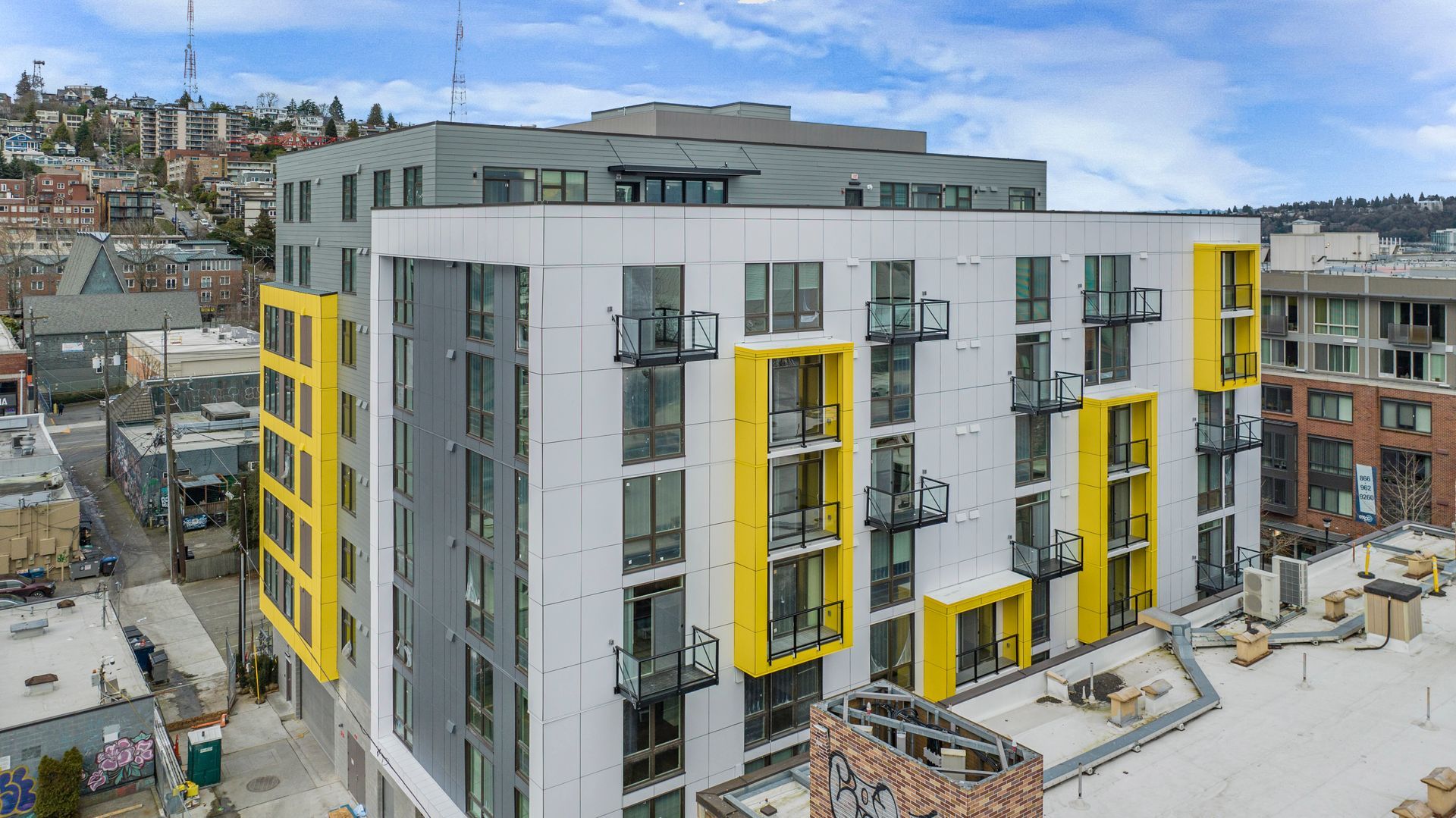 An aerial view of a large apartment building under construction in a city.