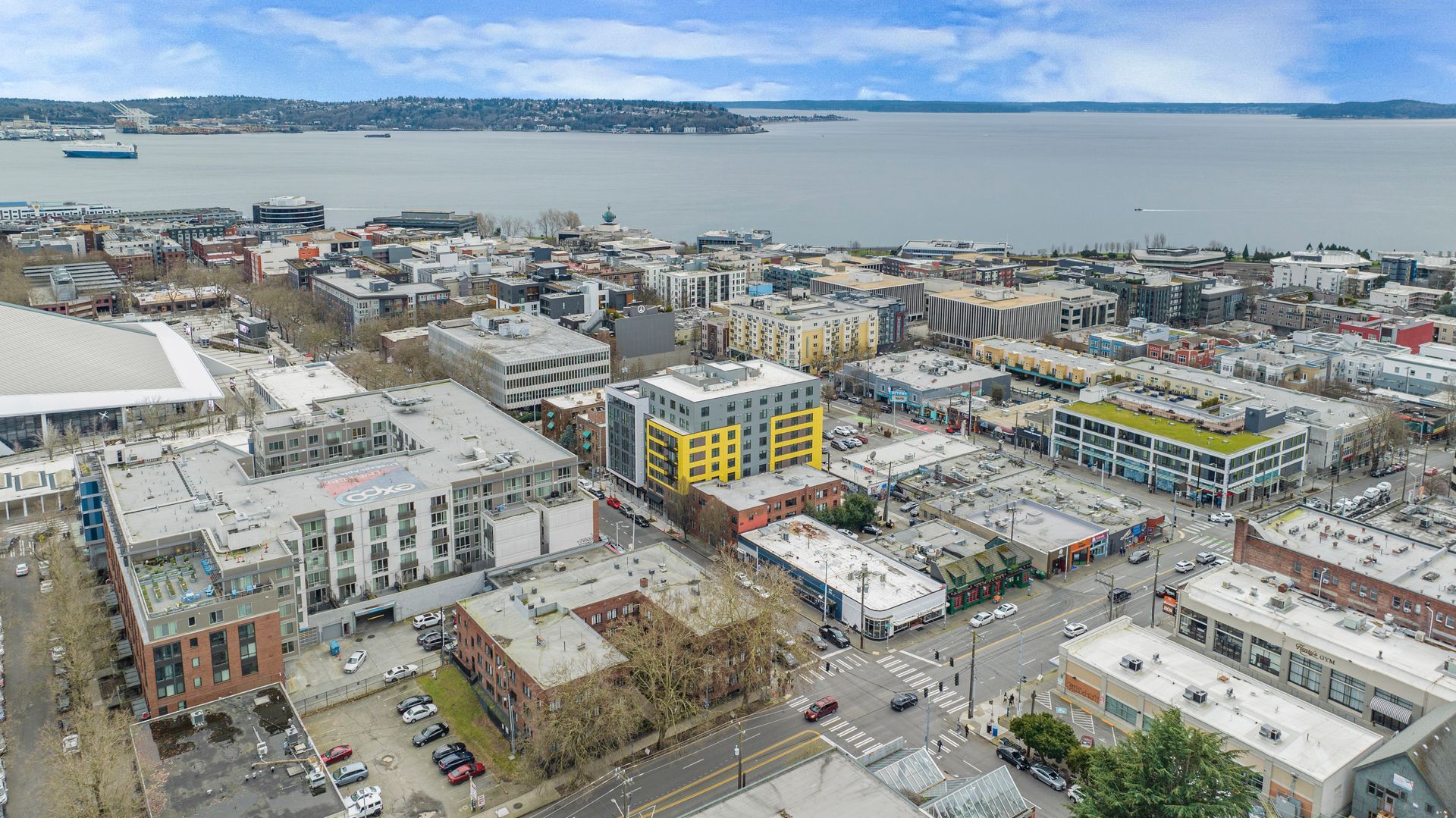 An aerial view of a city with a large body of water in the background.