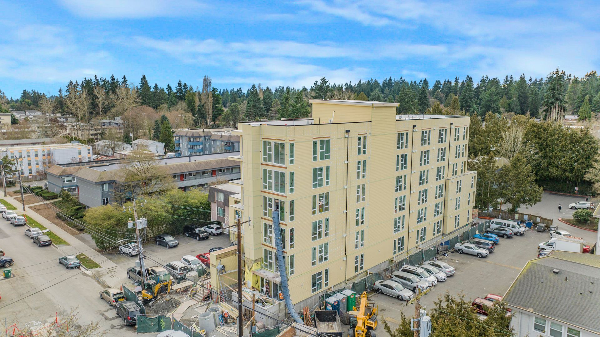 An aerial view of a building under construction in a city.