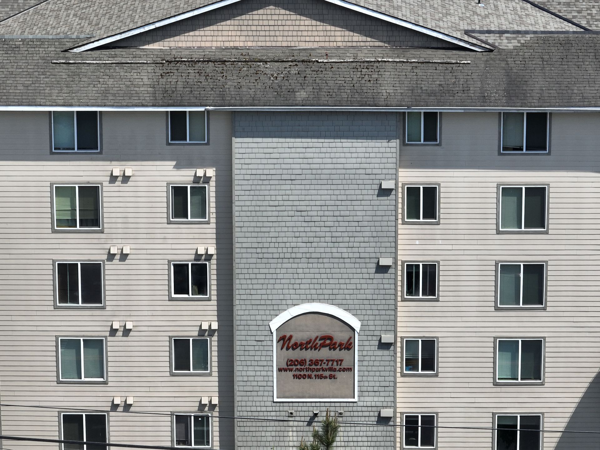 A large apartment building with a sign on the side that says ' kent point '
