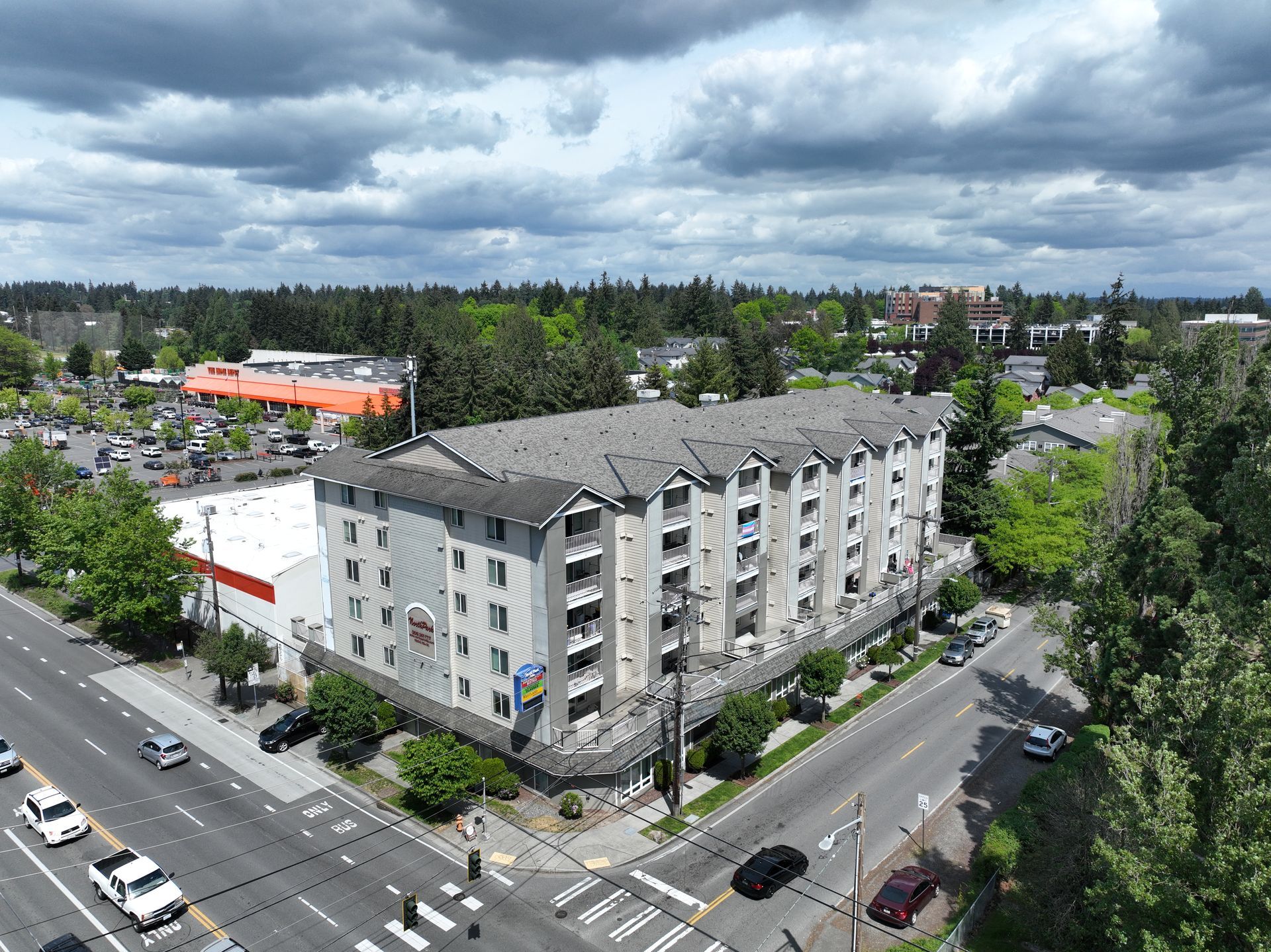 An aerial view of a large apartment building on a cloudy day