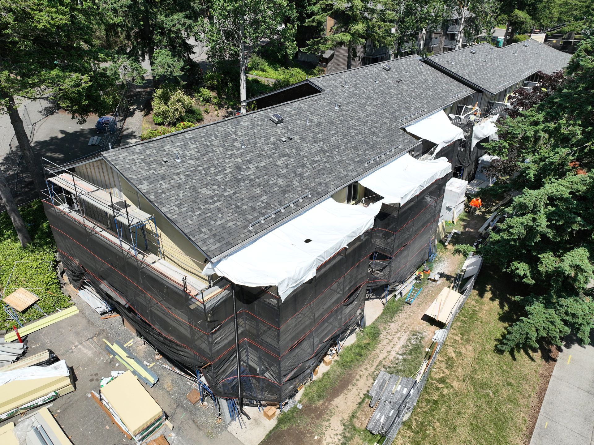 An aerial view of a house under construction with scaffolding around it.