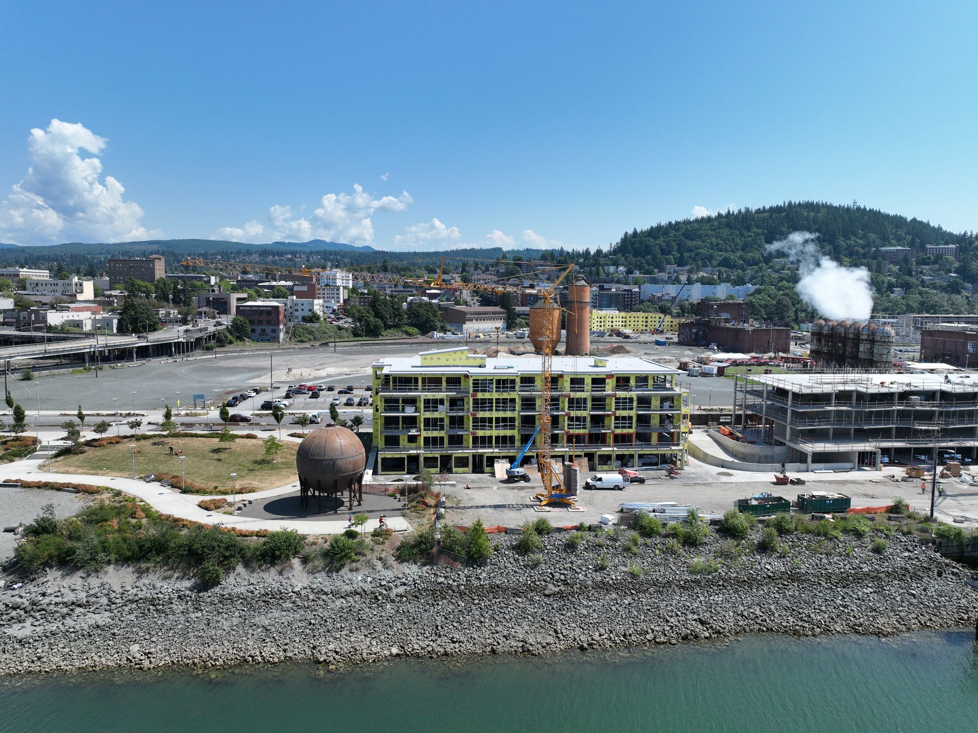 An aerial view of a building under construction next to a river.