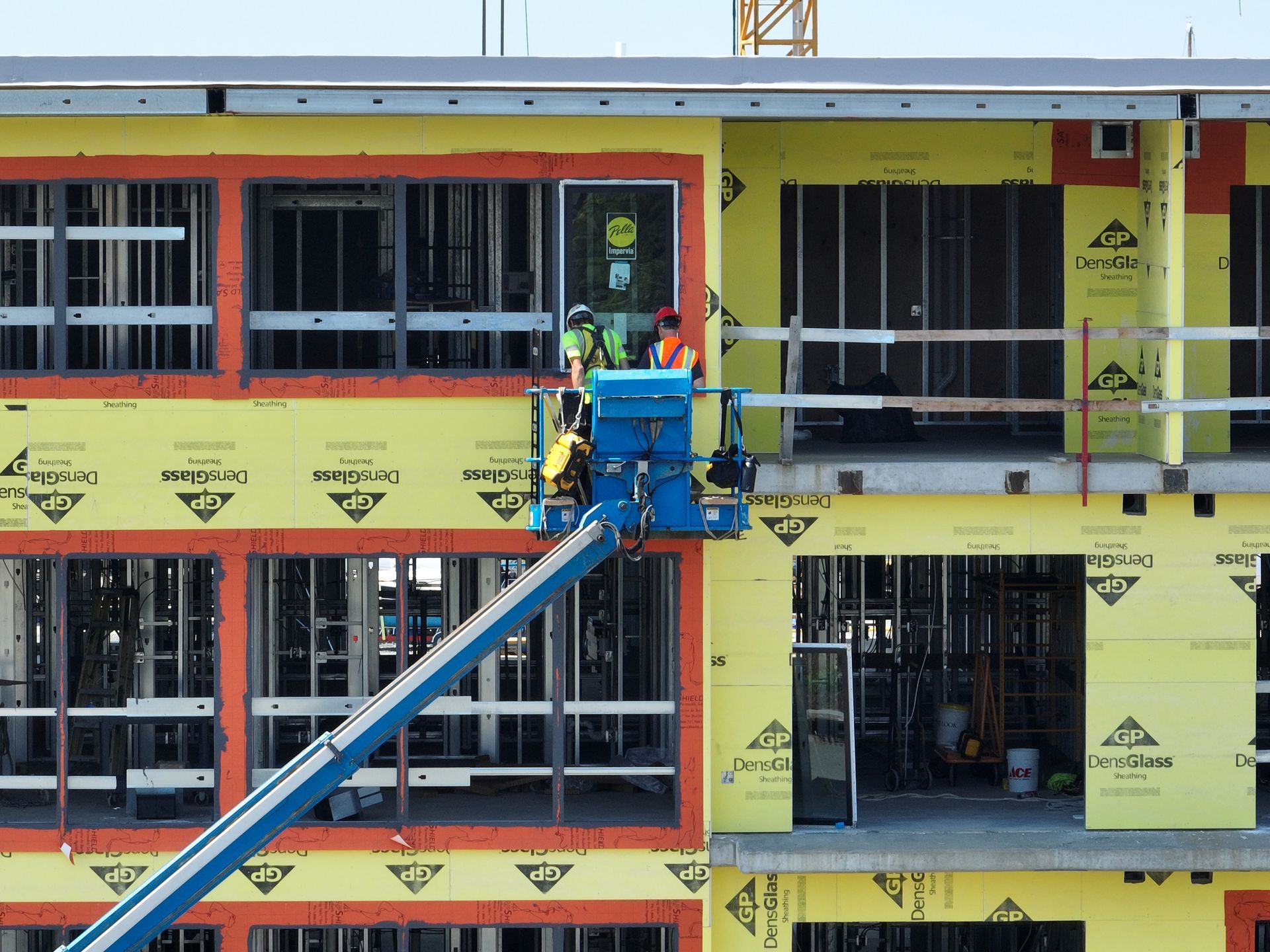 A group of construction workers are working on a building under construction.