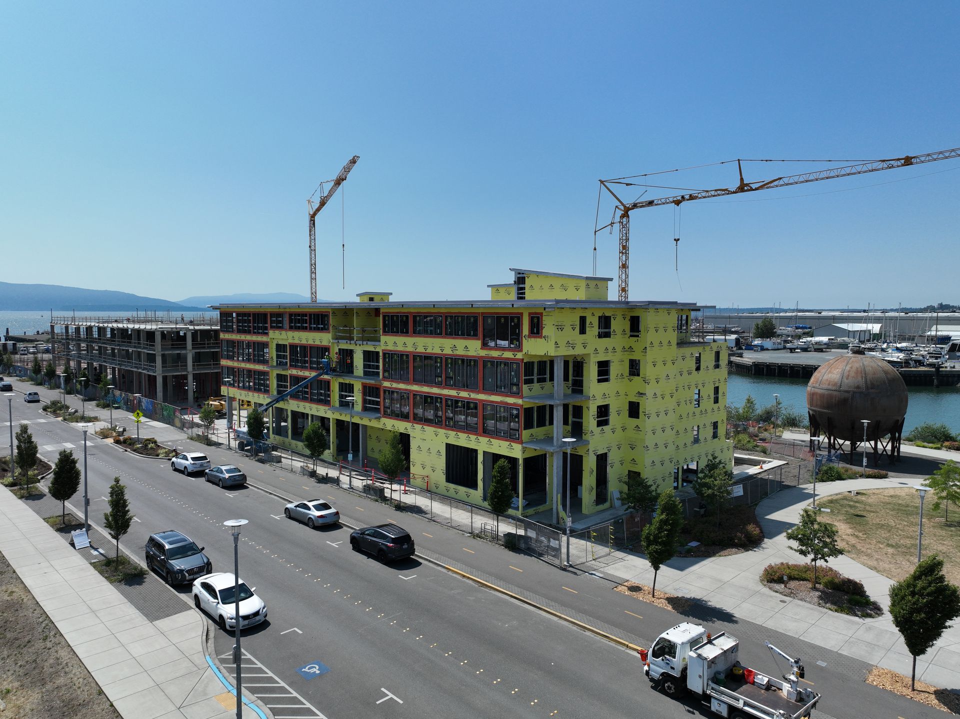 An aerial view of a building under construction on a city street