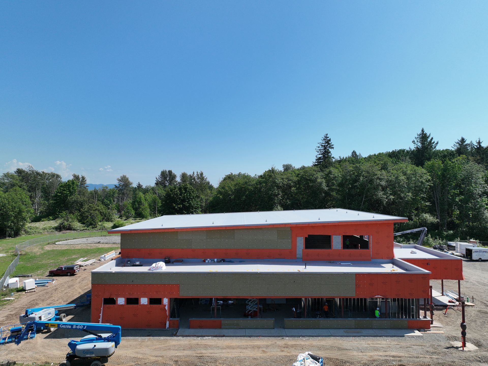 An aerial view of a building under construction in the middle of a field.