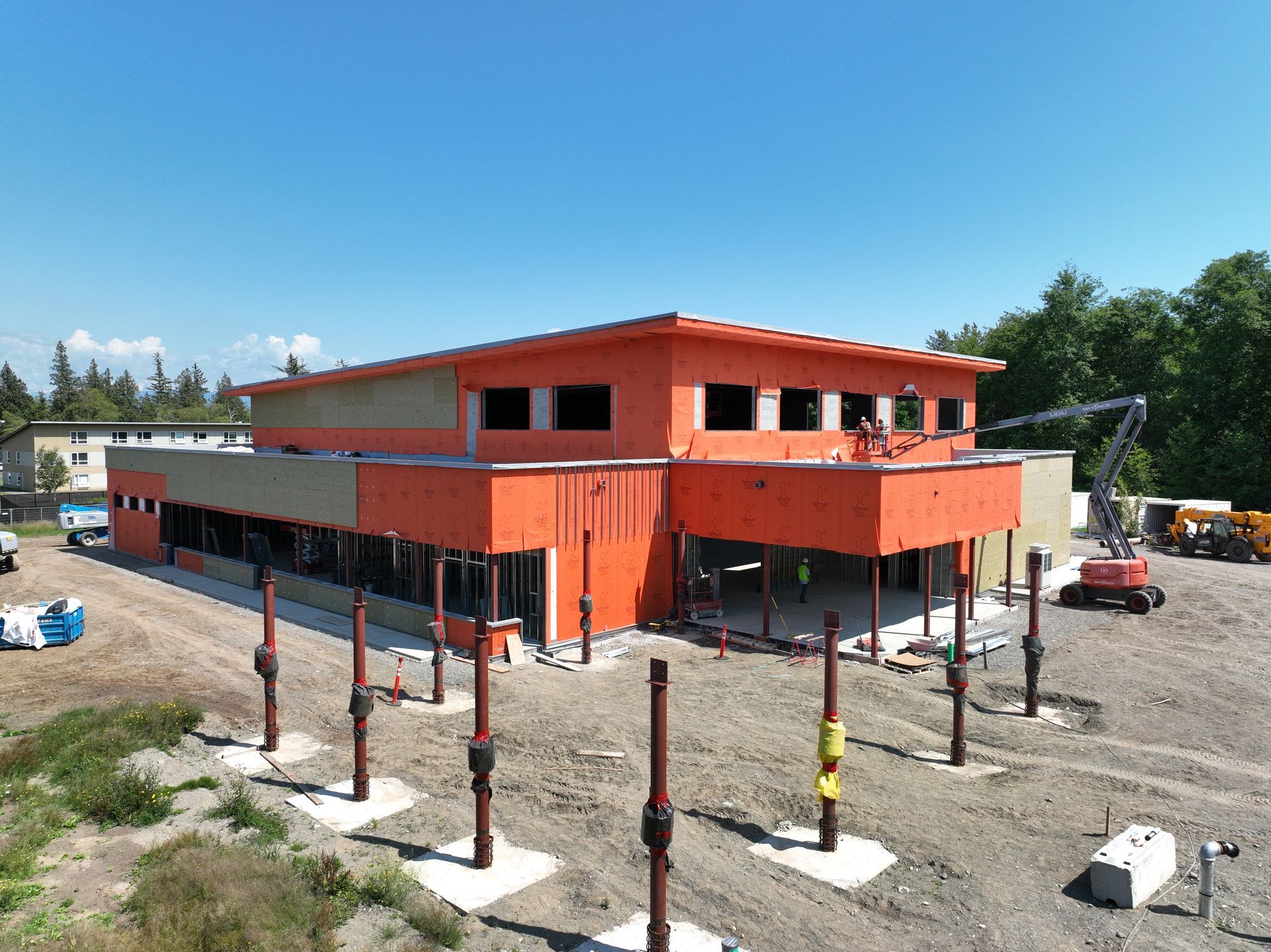 An aerial view of a large orange building under construction.