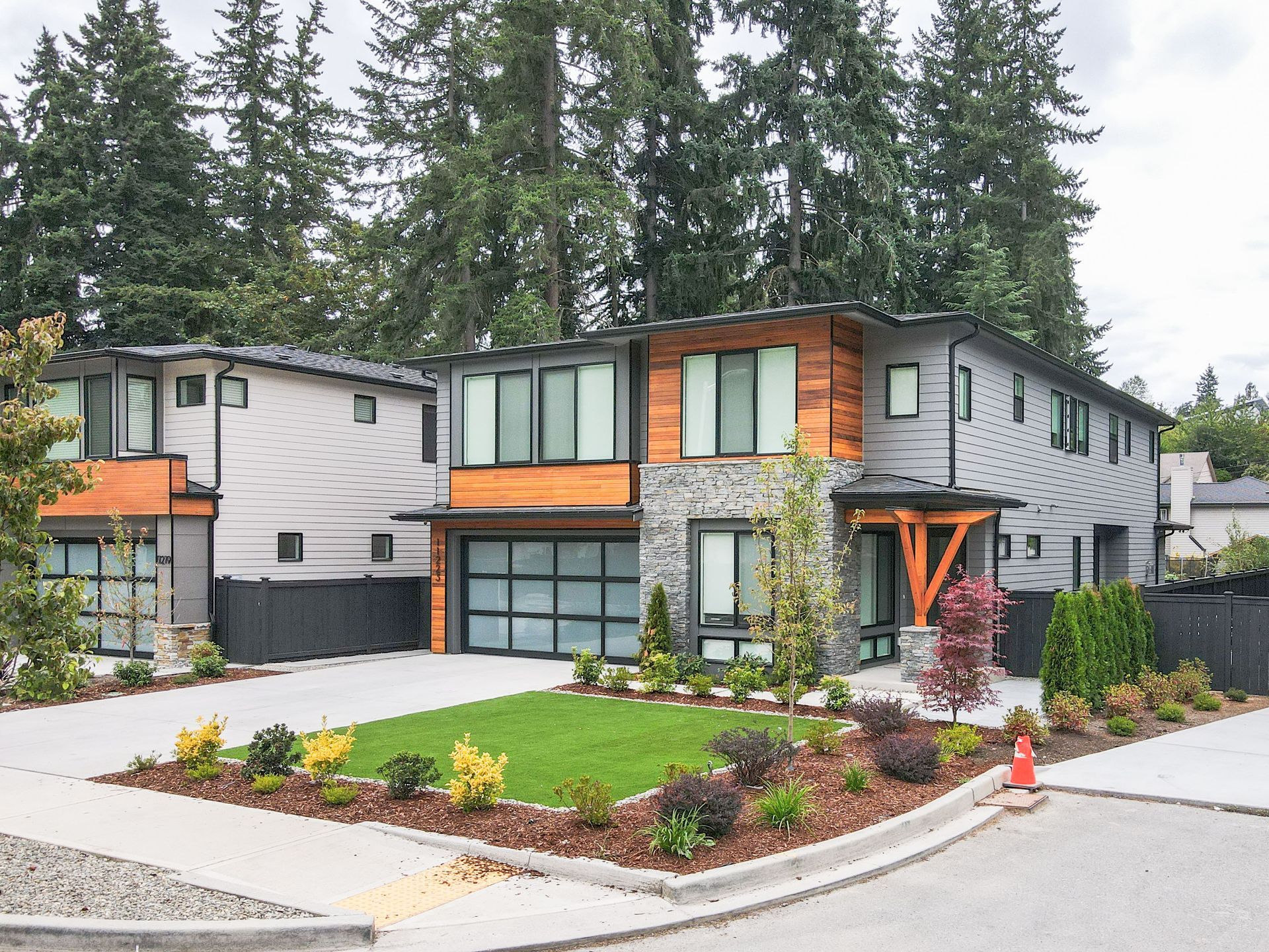 A house with a lot of windows and a lush green lawn