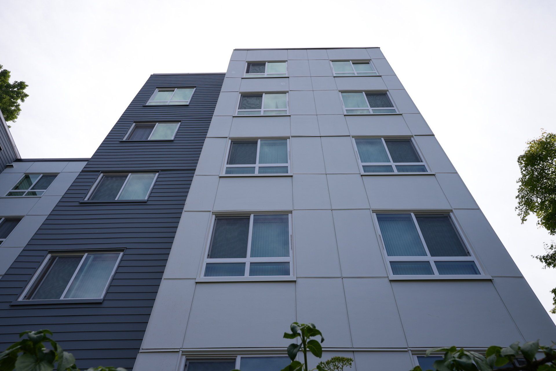 Looking up at a tall building with lots of windows