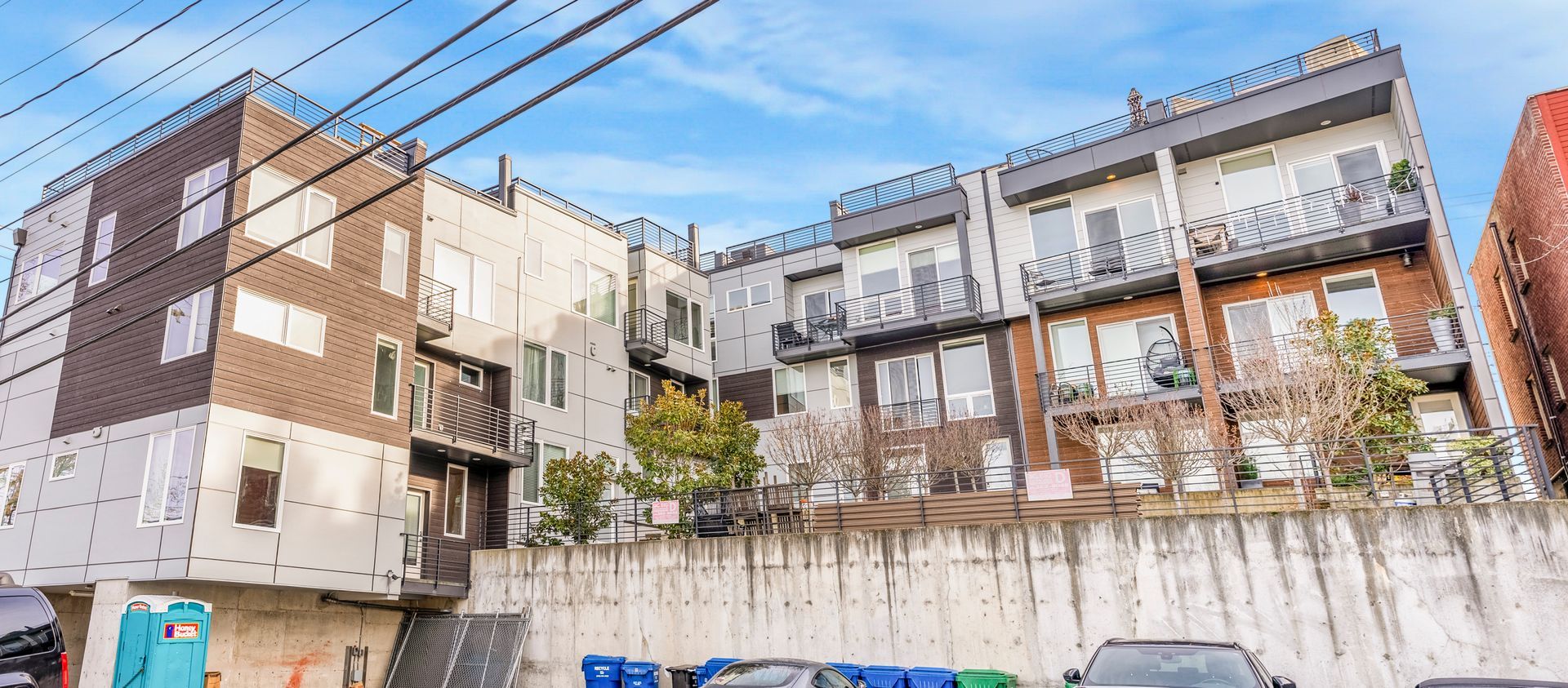 A large building with a lot of windows and cars parked in front of it.