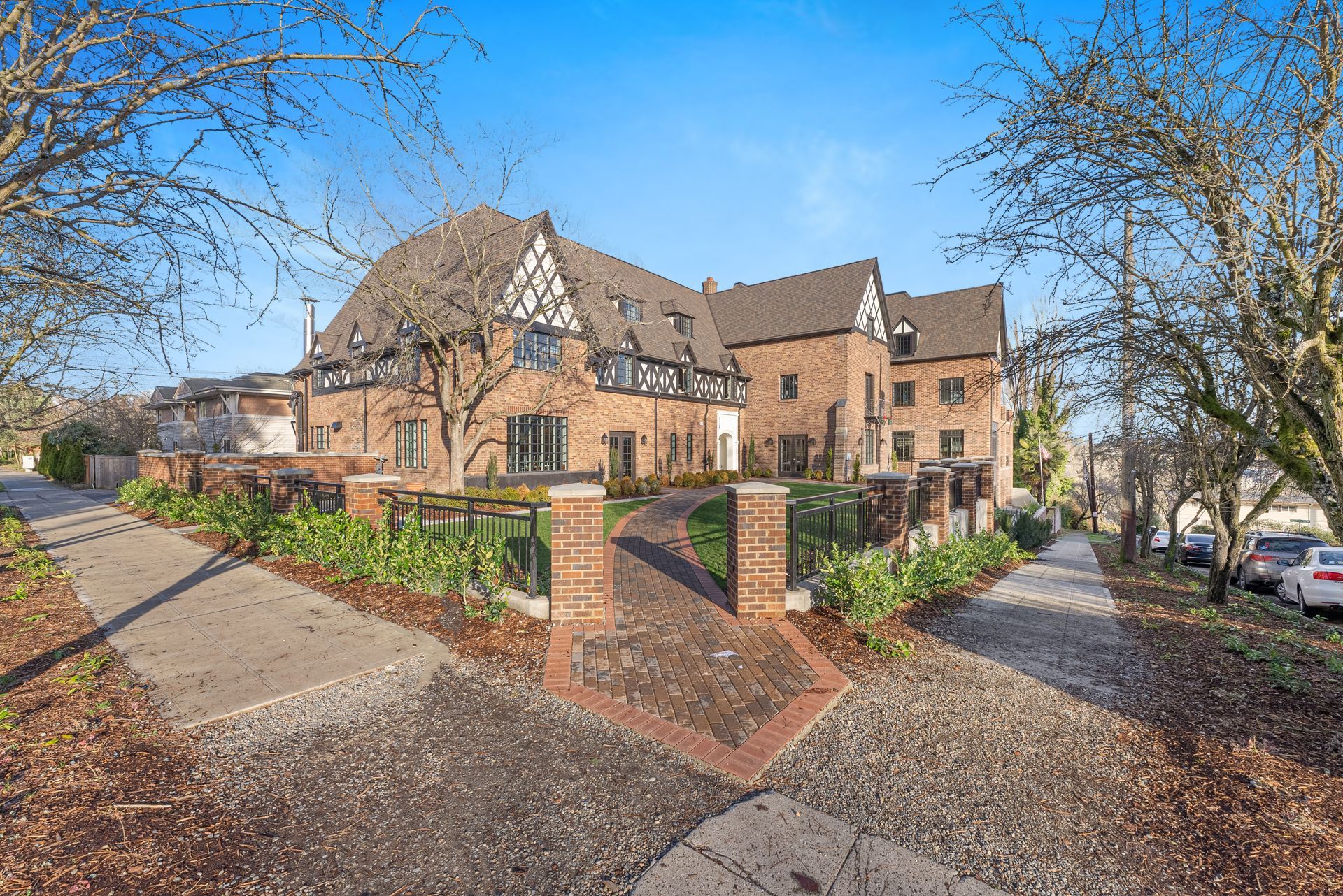 A large brick building with a walkway leading to it is for sale.