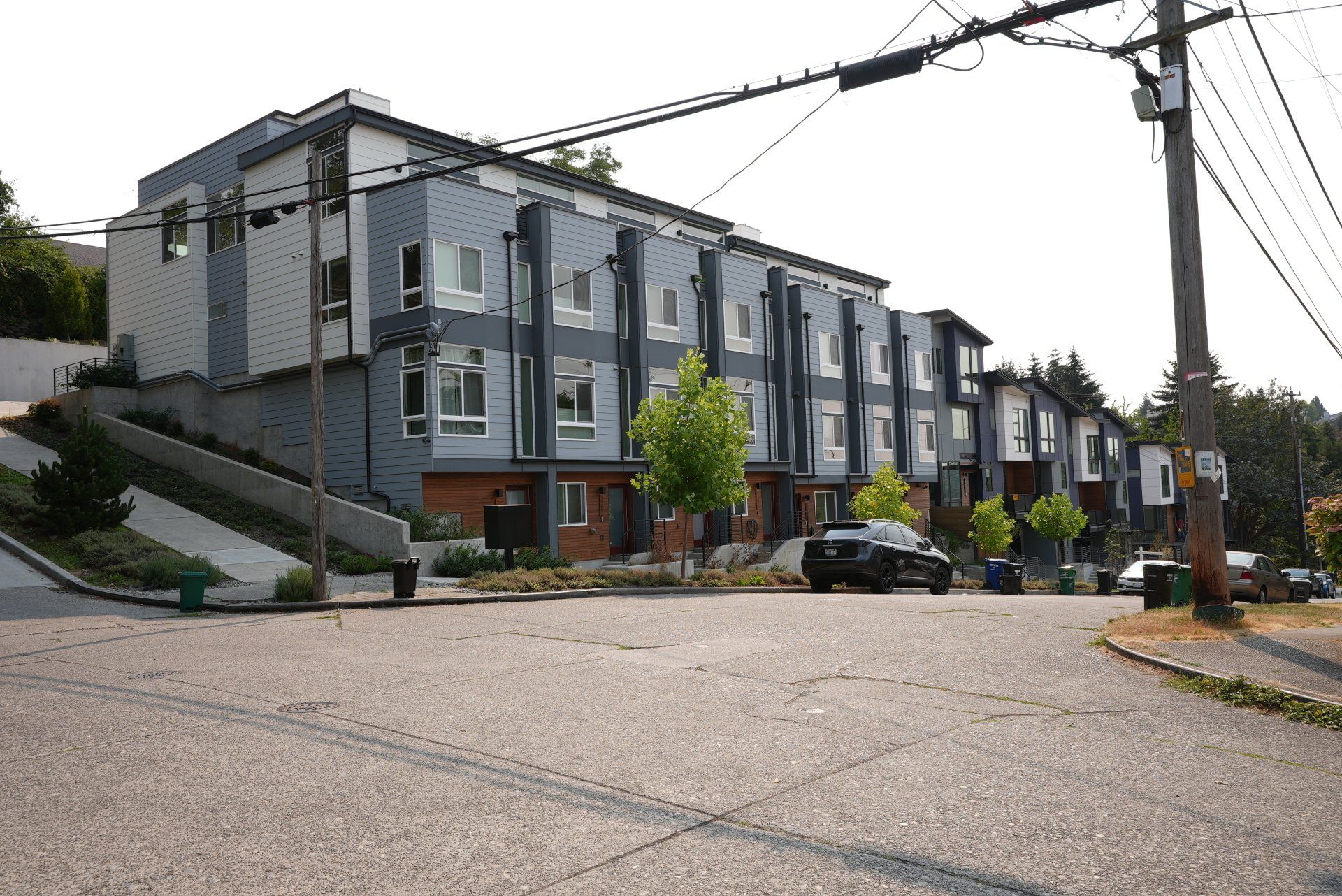 A building with a lot of windows is sitting on top of a hill.