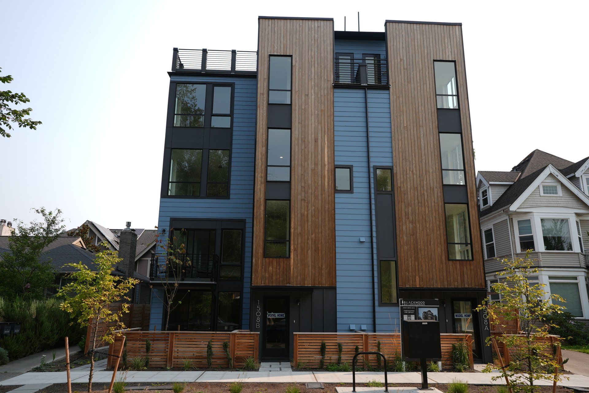 A blue and wooden building with a lot of windows