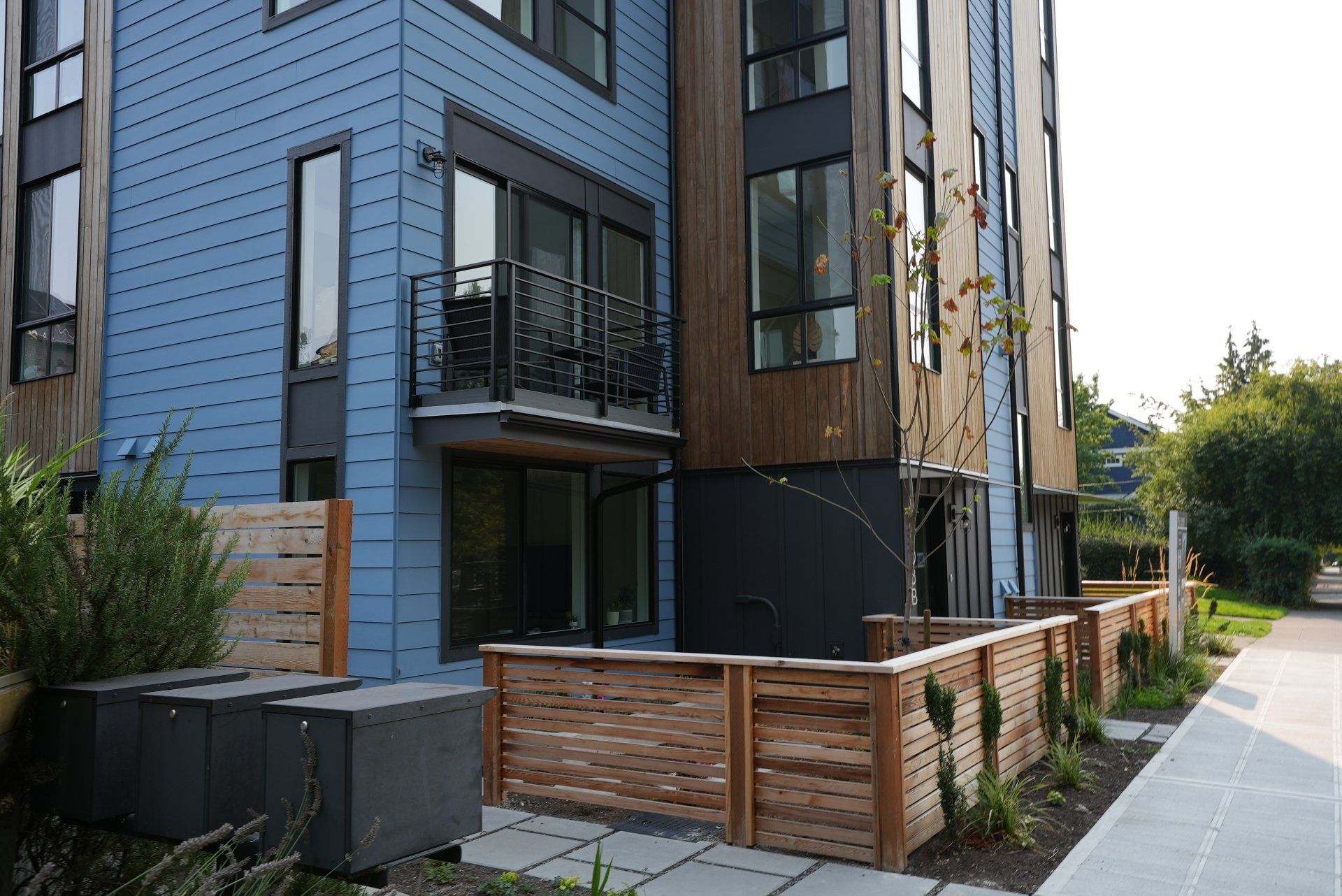 A blue building with a wooden fence in front of it