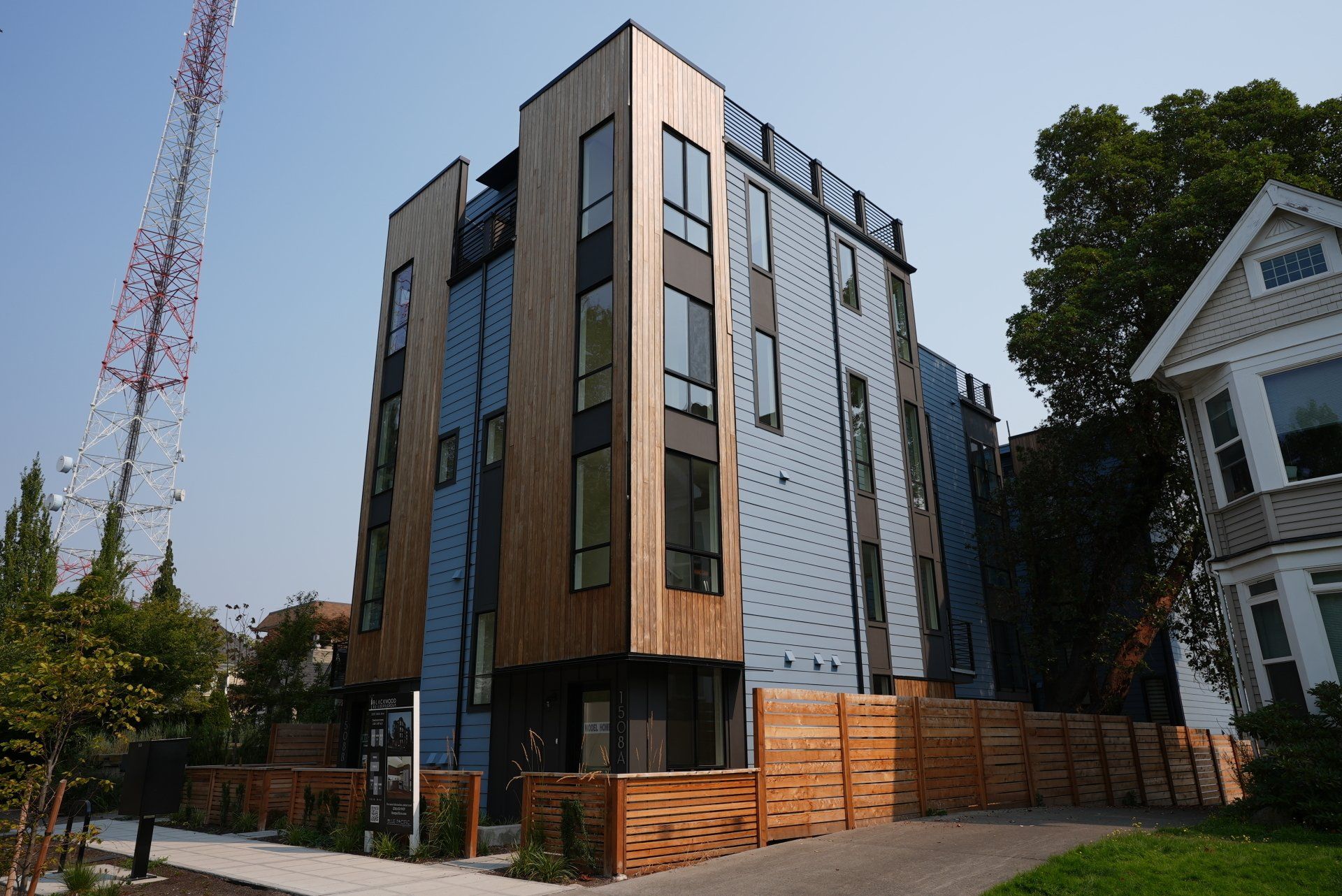 A large building with a lot of windows and a wooden fence