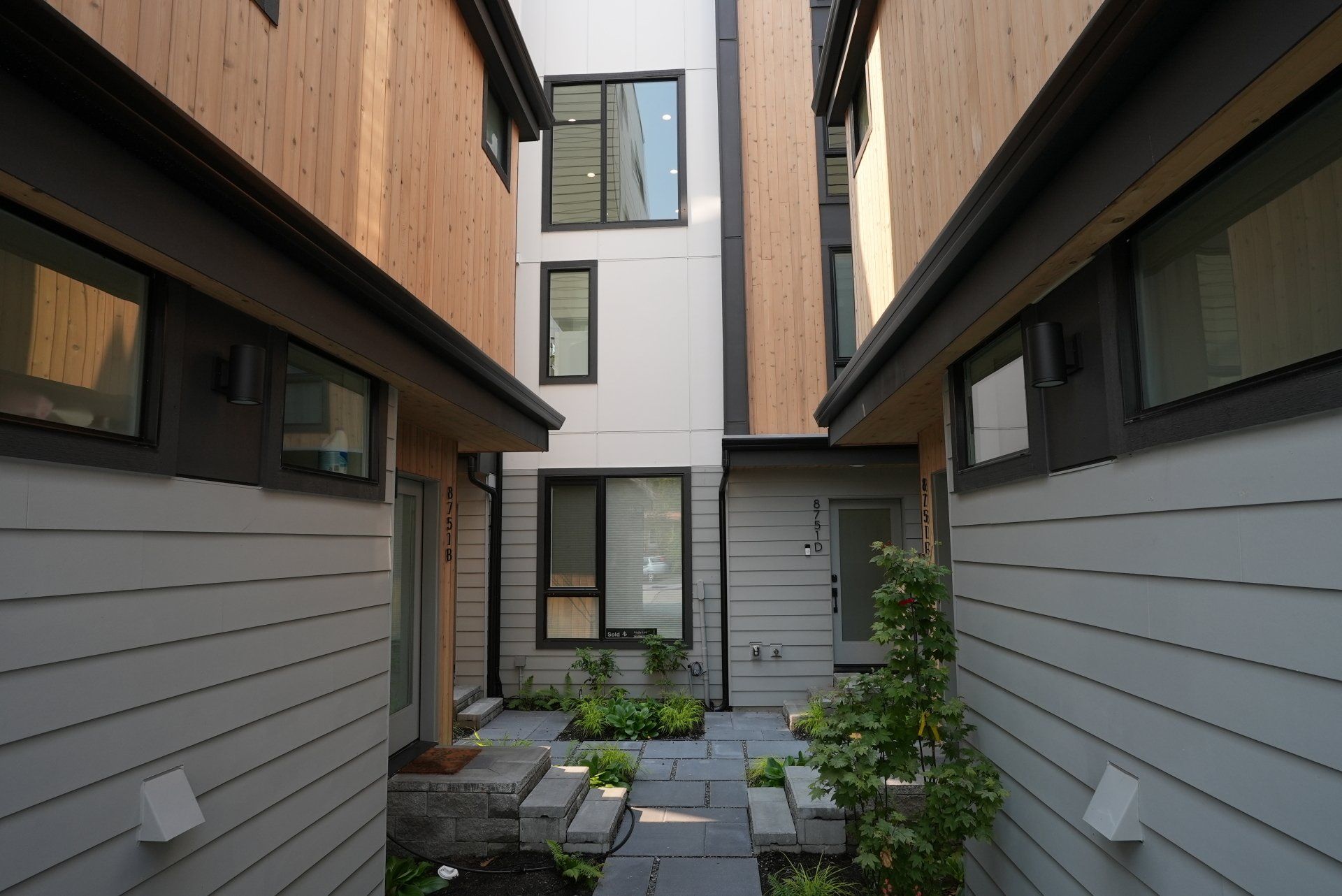 A narrow alleyway between two buildings with stairs