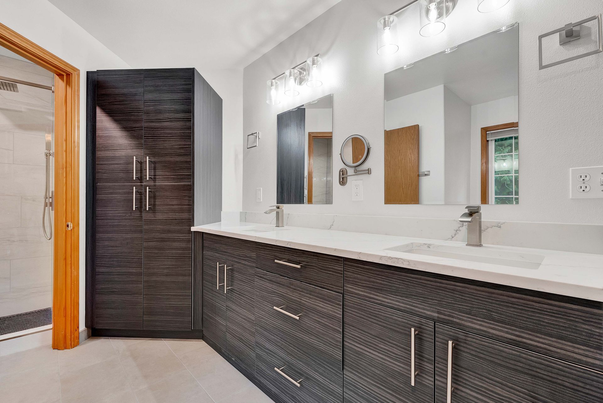 A bathroom with two sinks and a large mirror.
