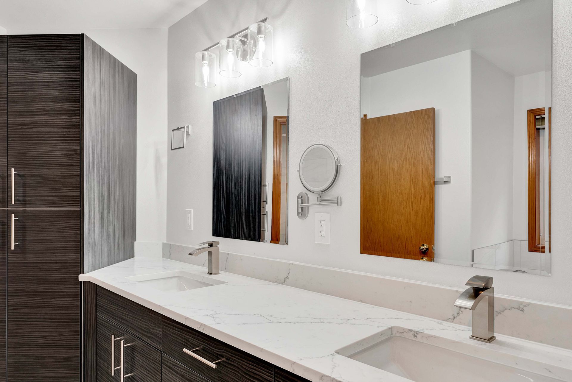 A bathroom with two sinks and two mirrors.