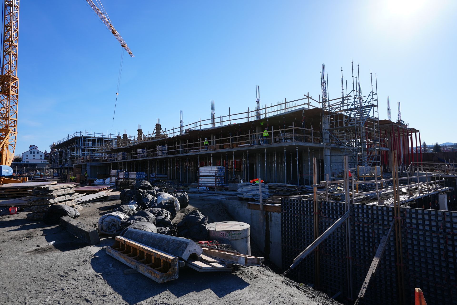 A large building under construction with a crane in the background.