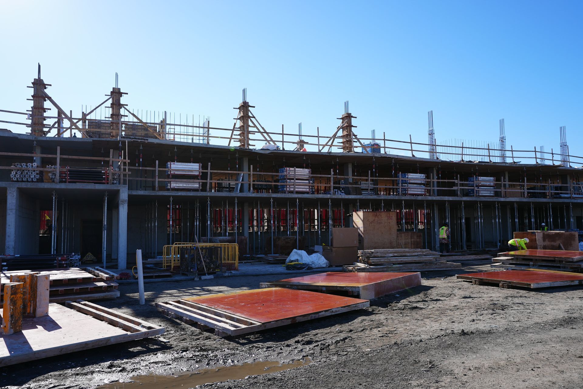 A large building is being built on a sunny day.