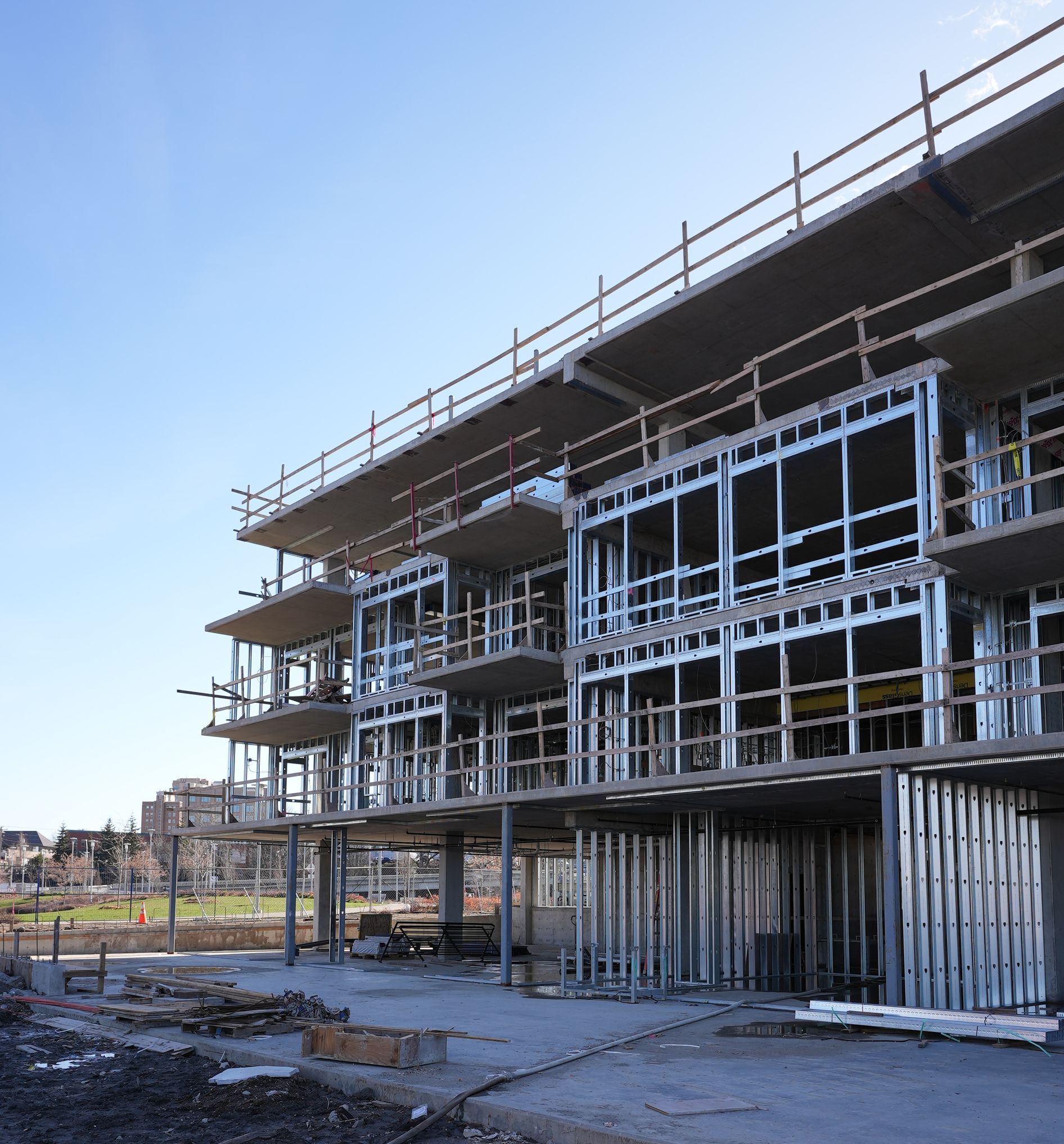 A large building under construction with a blue sky in the background