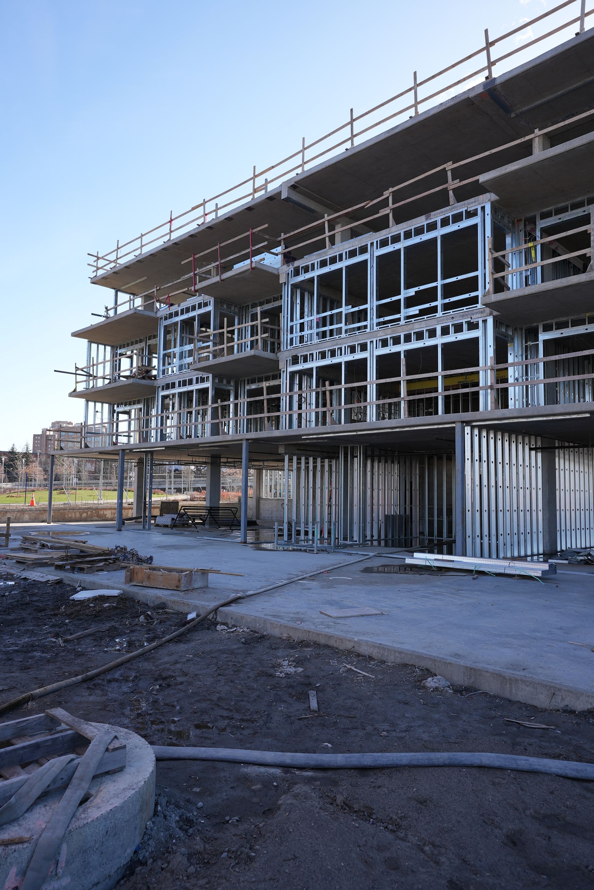 A large building under construction with a blue sky in the background