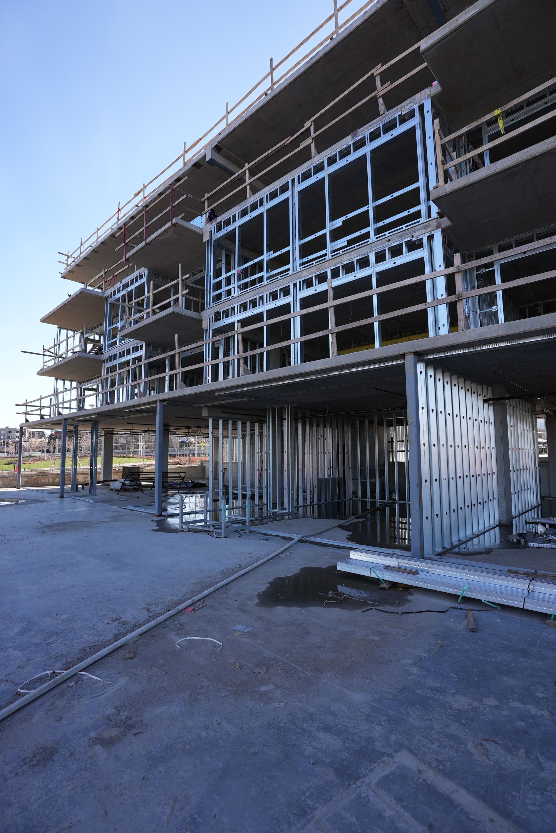 A large building is being built in a parking lot.