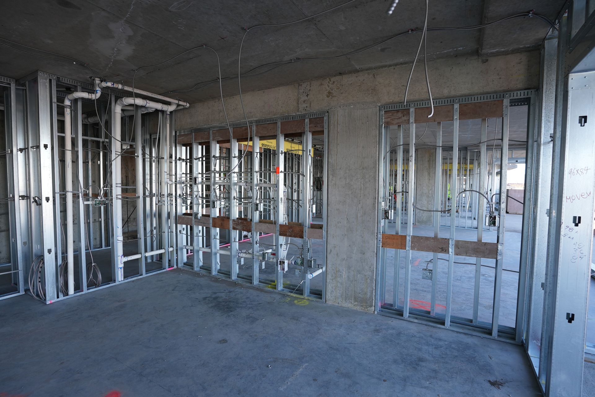 An empty room with a lot of metal frames on the walls.