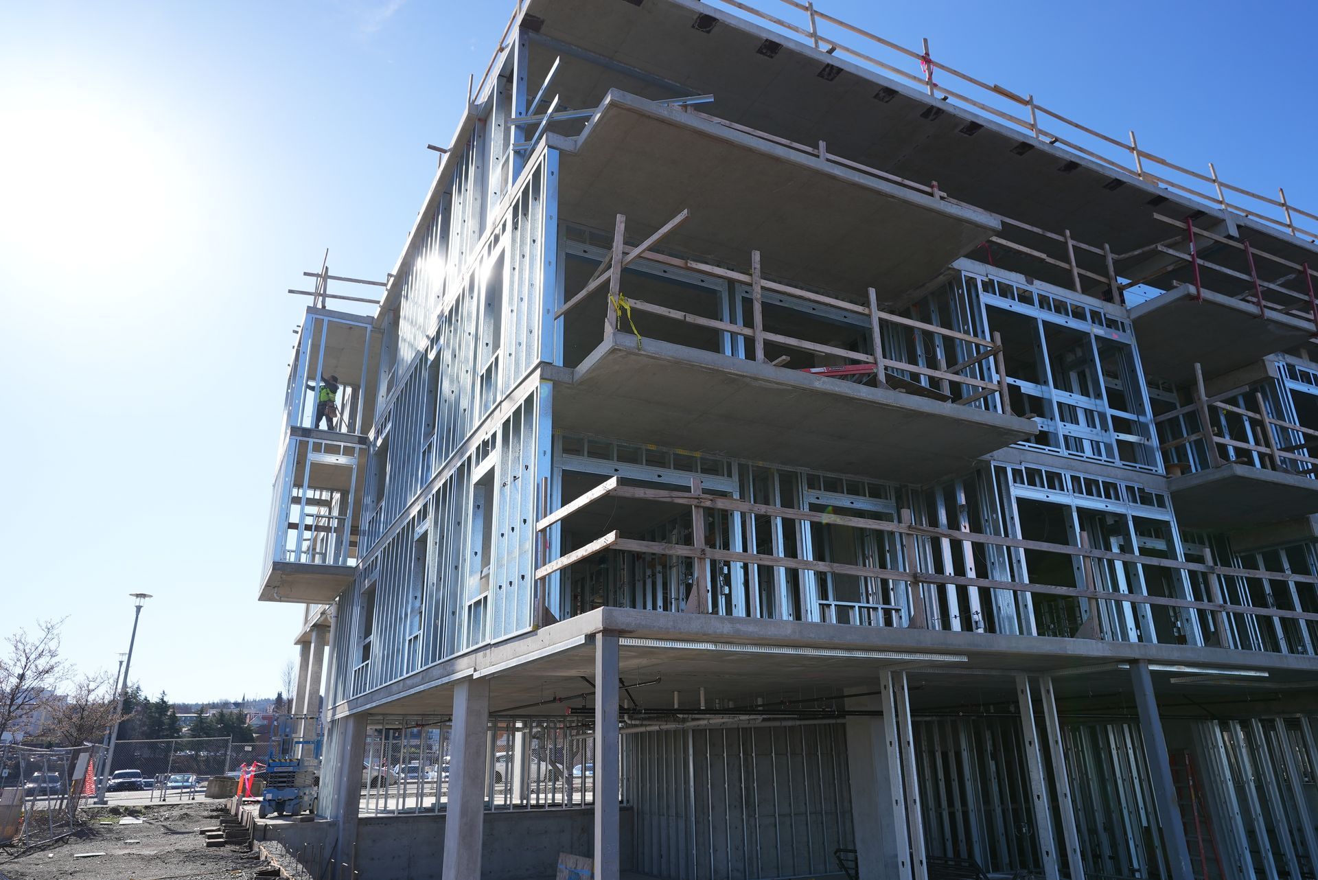 A large building under construction with a blue sky in the background.