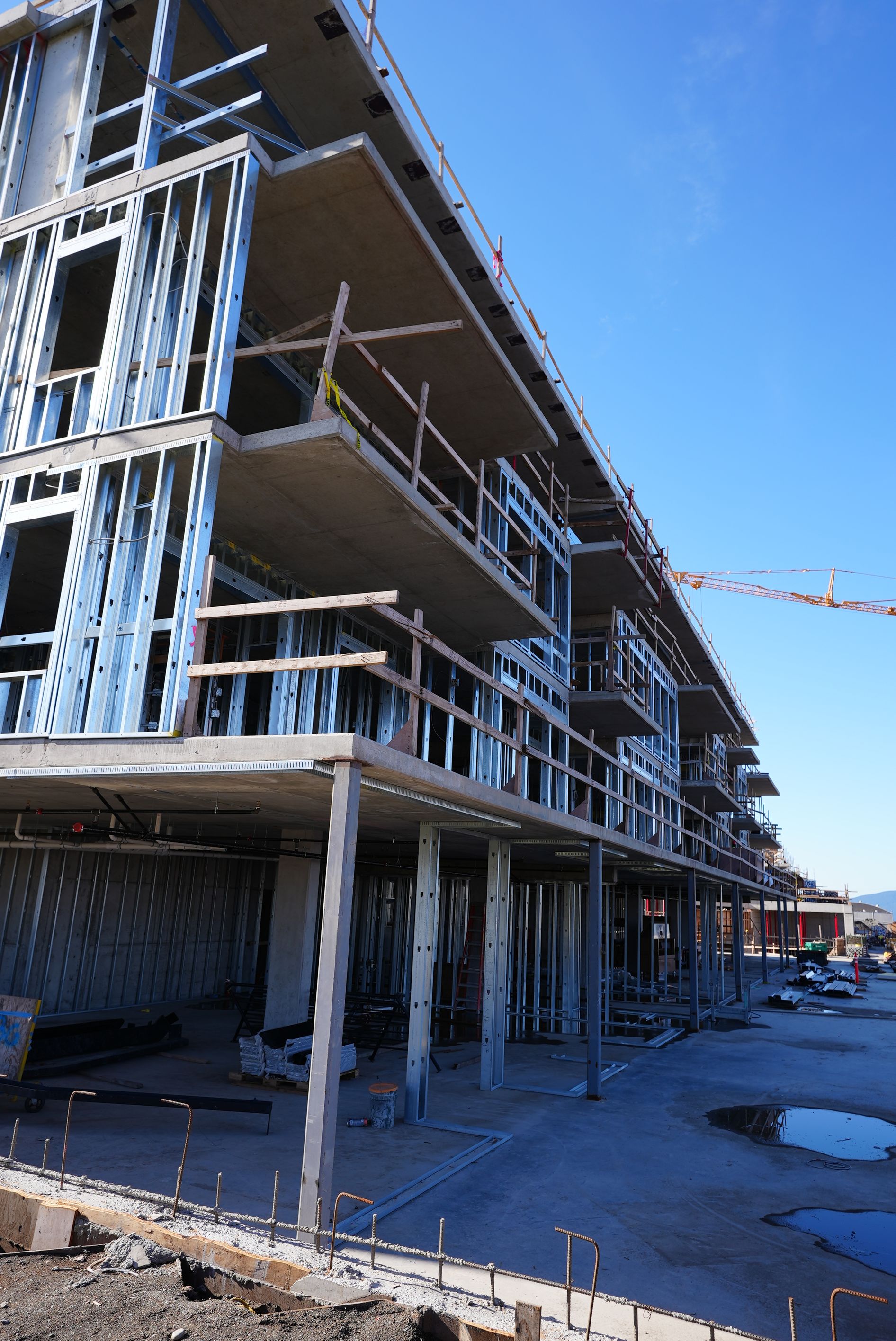 A large building under construction with a blue sky in the background