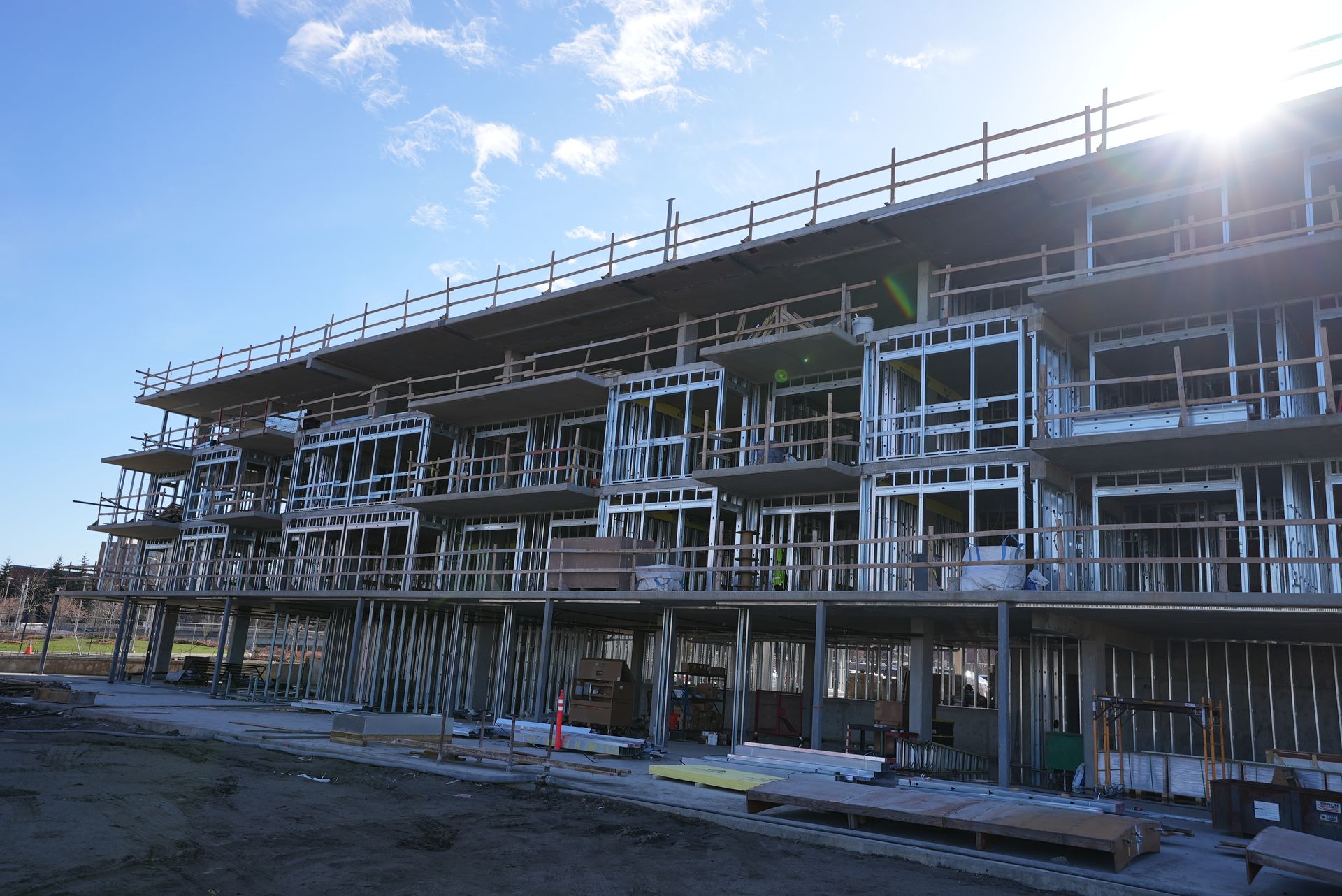 A large building under construction with the sun shining through the windows.