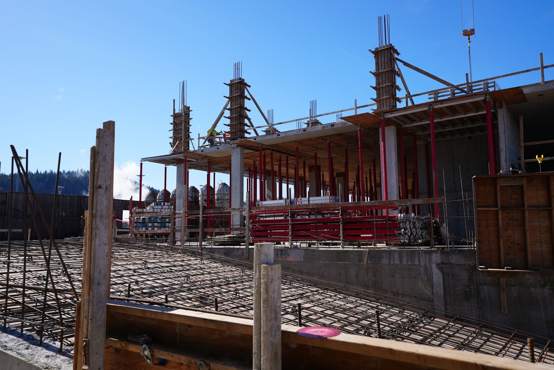 A large building under construction with a blue sky in the background