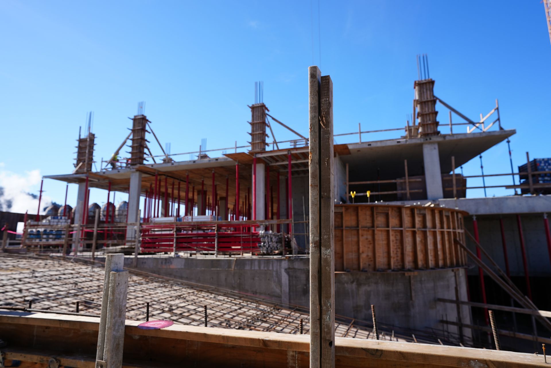 A large building under construction with a blue sky in the background
