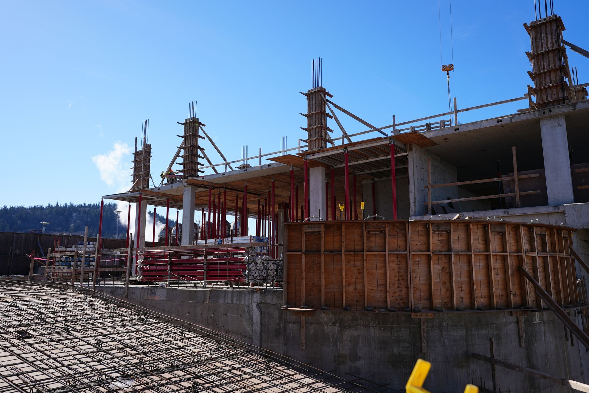 A large building under construction with a blue sky in the background