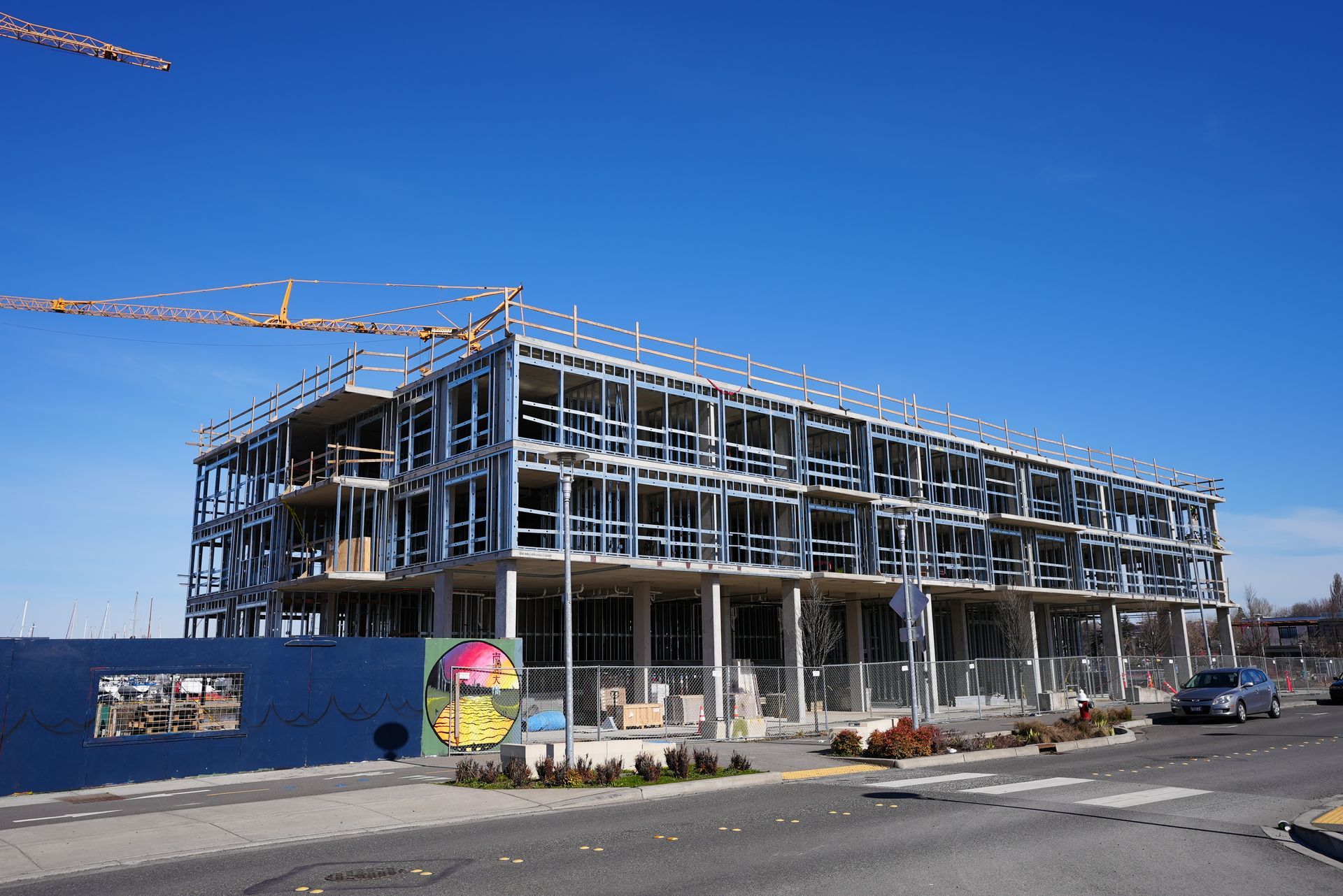 A large building under construction with a crane in the background