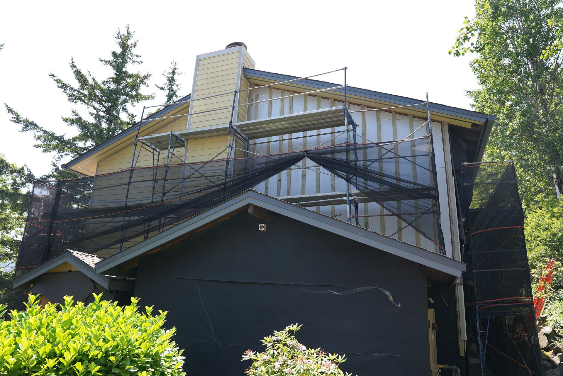A house that is being remodeled with scaffolding around it