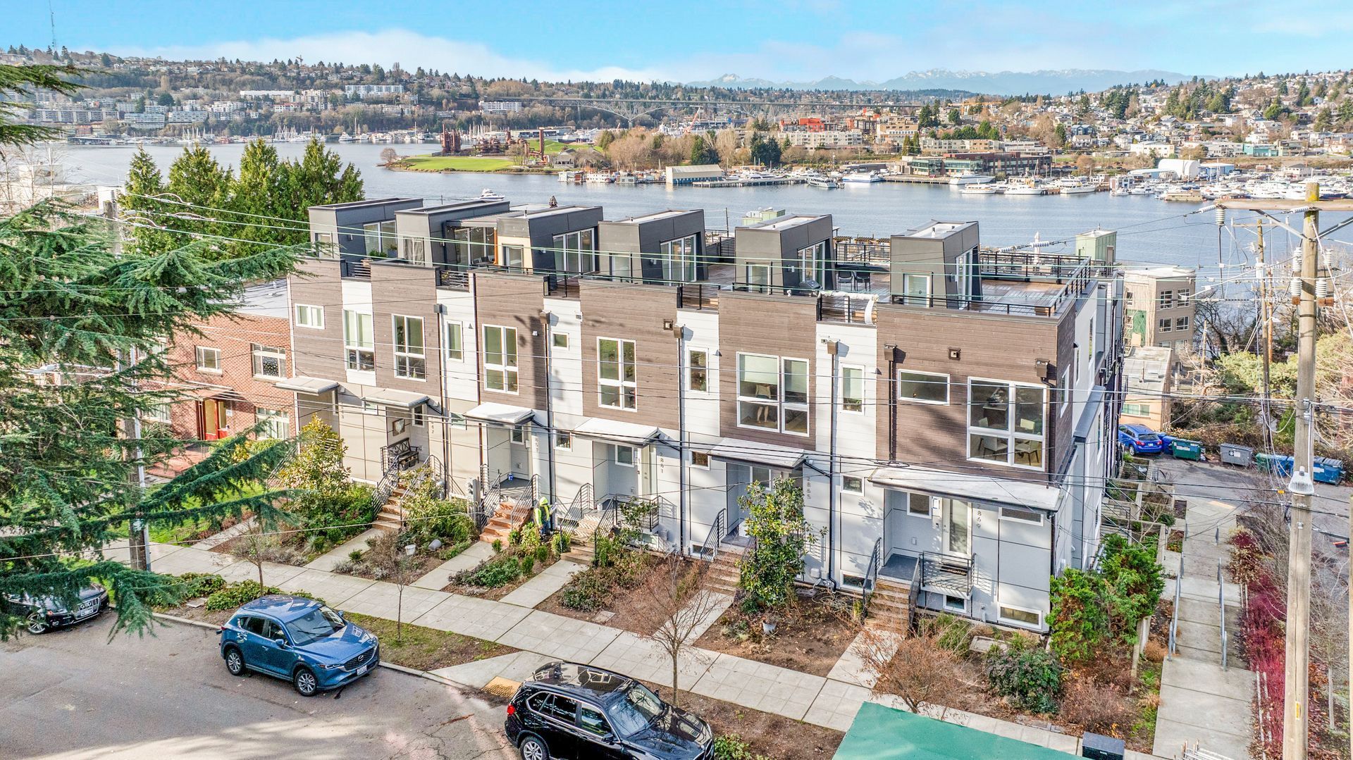 An aerial view of a row of houses next to a body of water.
