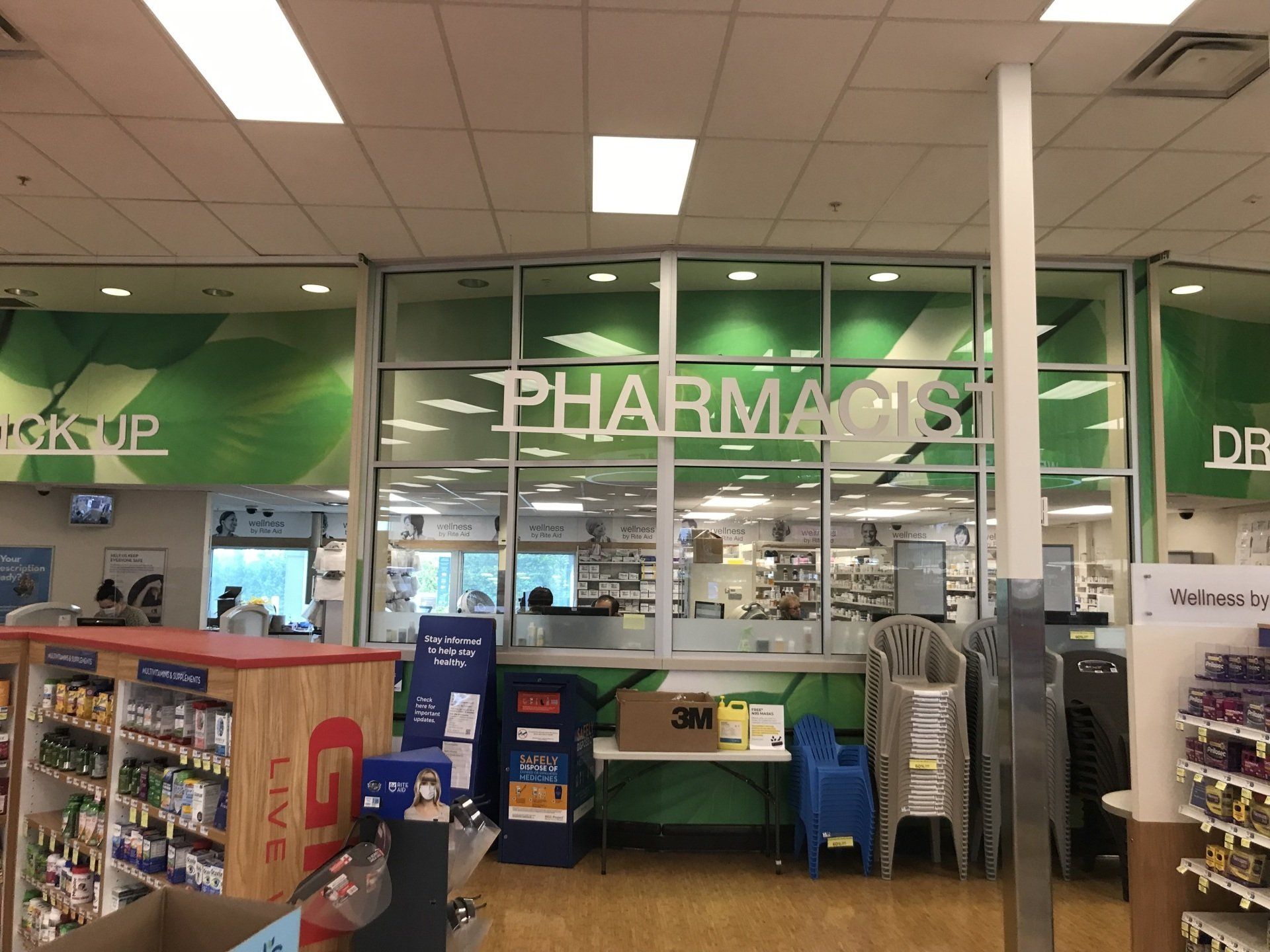 The inside of a pharmacy with a sign that says pharmacy