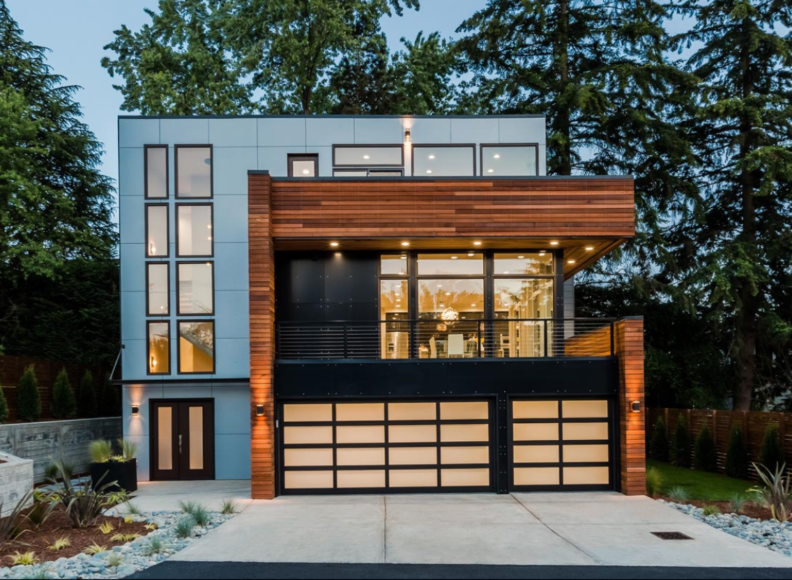 A modern house with a large garage and lots of windows