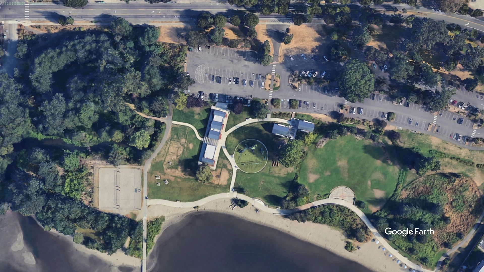 An aerial view of a park next to a body of water
