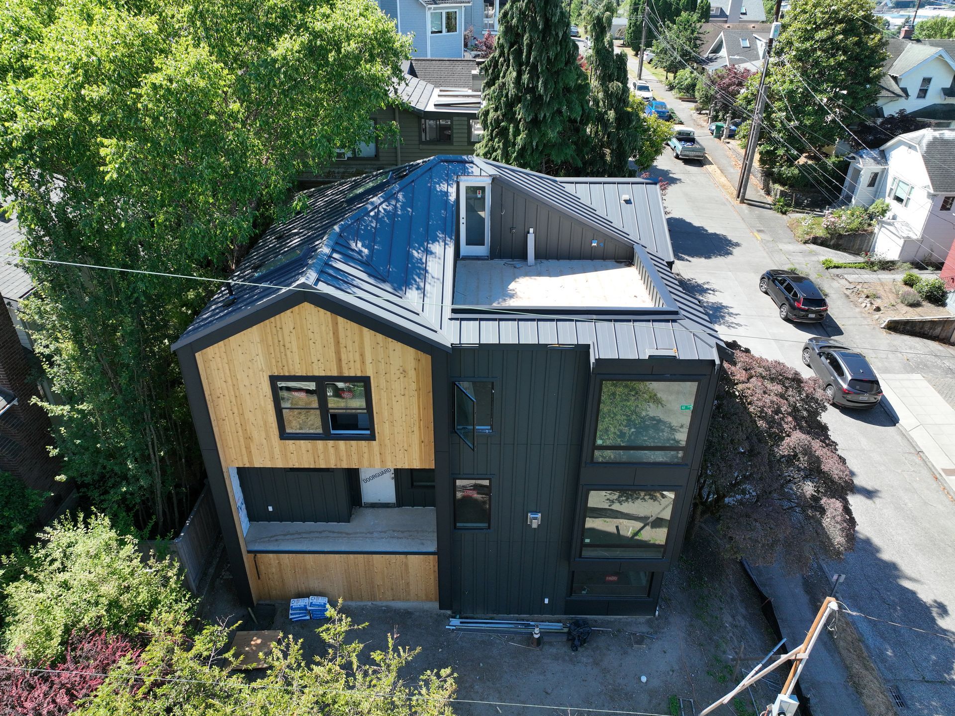 An aerial view of a house with a black roof