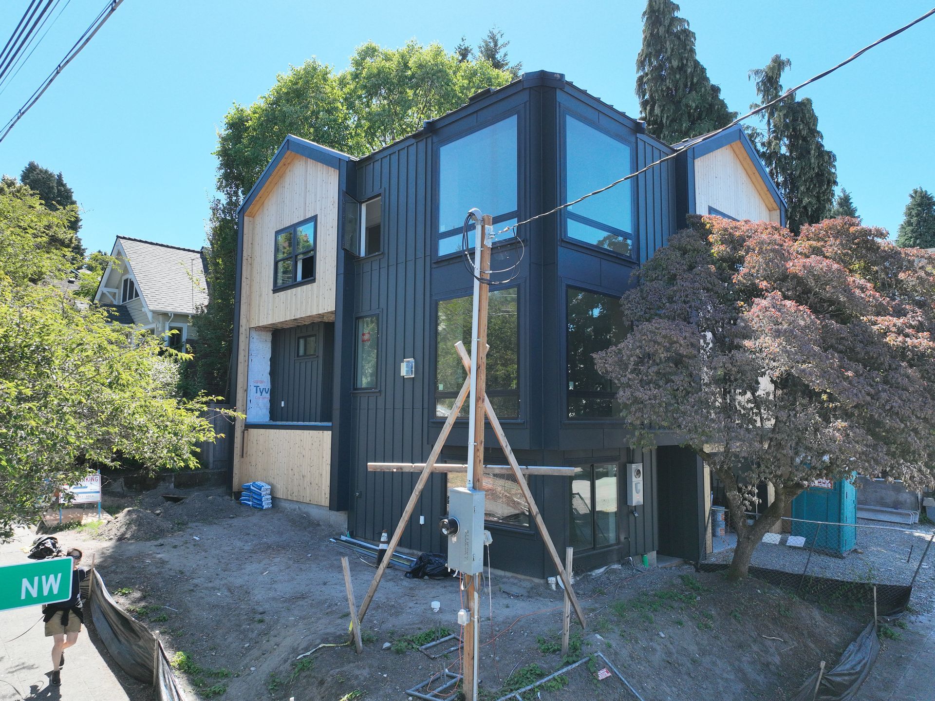 A house is being built on a hill and has a sign that says y.m.