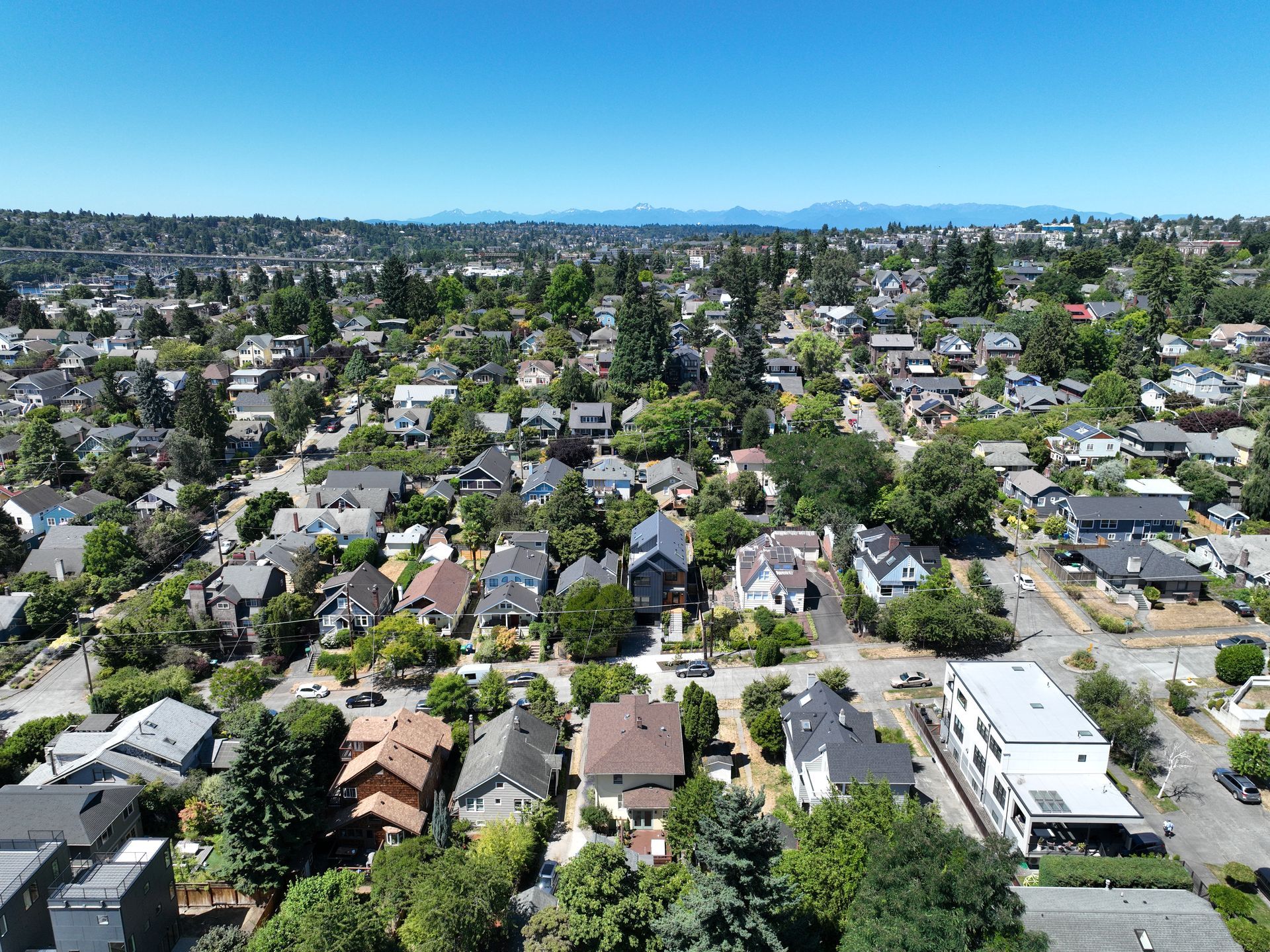 An aerial view of a residential area filled with lots of houses and trees.