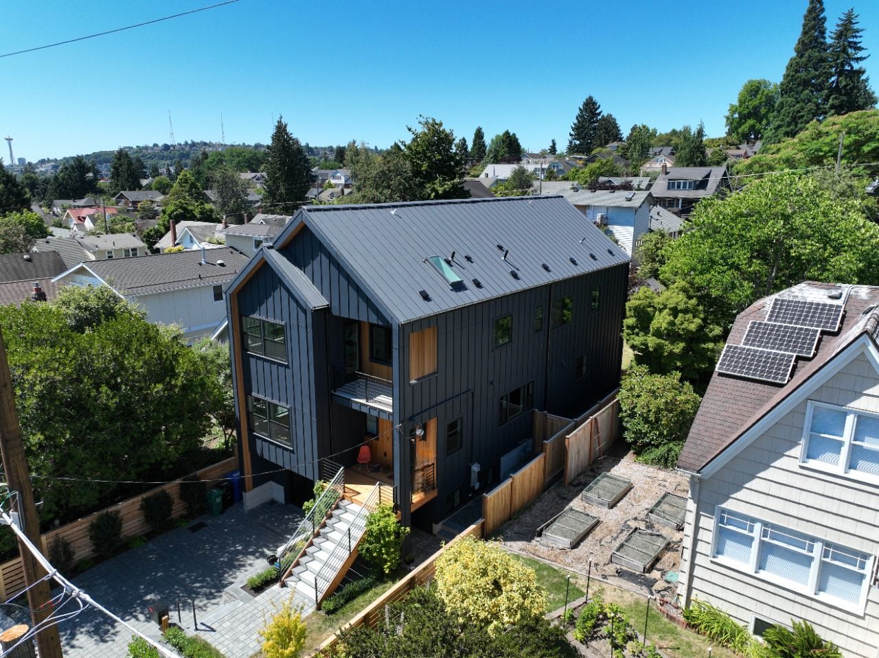 An aerial view of a house with solar panels on the roof
